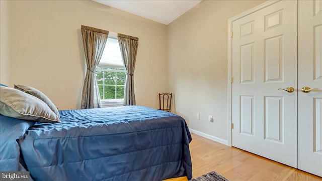 bedroom with light wood-style floors and baseboards