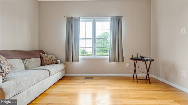 sitting room featuring light wood finished floors and baseboards