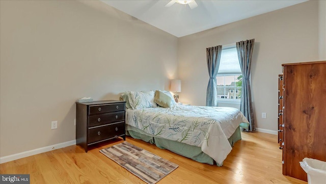 bedroom featuring wood finished floors, baseboards, and ceiling fan