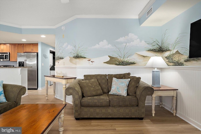 18 79th St Unit 403, Ocean City, MD 21842 - living area featuring light wood-style floors, ornamental molding, and a wainscoted wall
