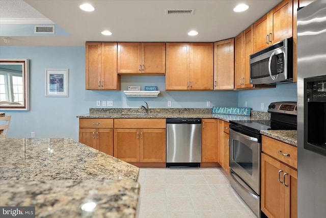 18 79th St Unit 403, Ocean City, MD 21842 - kitchen featuring stainless steel appliances, a sink, light stone counters, light tile patterned floors, and recessed lighting