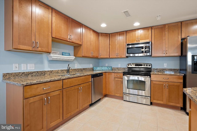 18 79th St Unit 403, Ocean City, MD 21842 - kitchen with appliances with stainless steel finishes, a sink, brown cabinets, stone counters, and recessed lighting