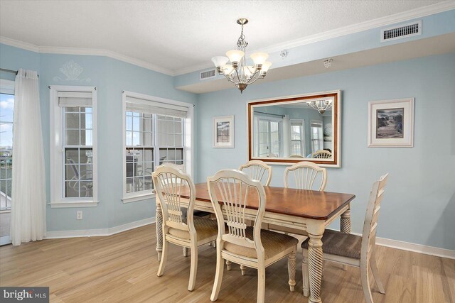 18 79th St Unit 403, Ocean City, MD 21842 - dining room with a chandelier, light wood finished floors, healthy amount of natural light, and ornamental molding