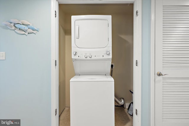 18 79th St Unit 403, Ocean City, MD 21842 - laundry area featuring stacked washing machine and dryer and light tile patterned floors