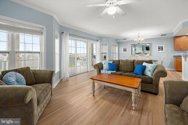18 79th St Unit 403, Ocean City, MD 21842 - living area featuring a chandelier, light wood-style floors, crown molding, a ceiling fan, and baseboards