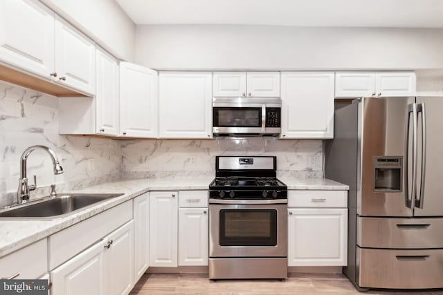 2012 Eagle St, Baltimore, MD 21223 - kitchen with a sink, stainless steel appliances, and white cabinetry