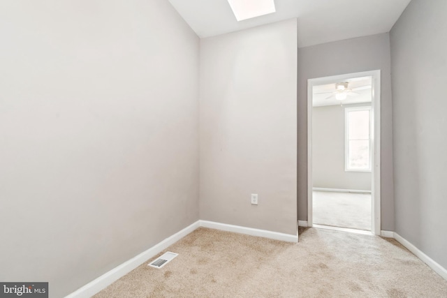 2012 Eagle St, Baltimore, MD 21223 - unfurnished room with a skylight, baseboards, visible vents, and light colored carpet