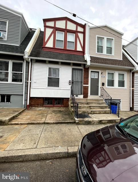 multi unit property with entry steps and roof with shingles