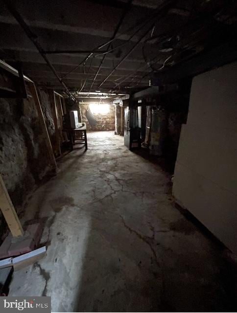 unfinished basement featuring heating unit