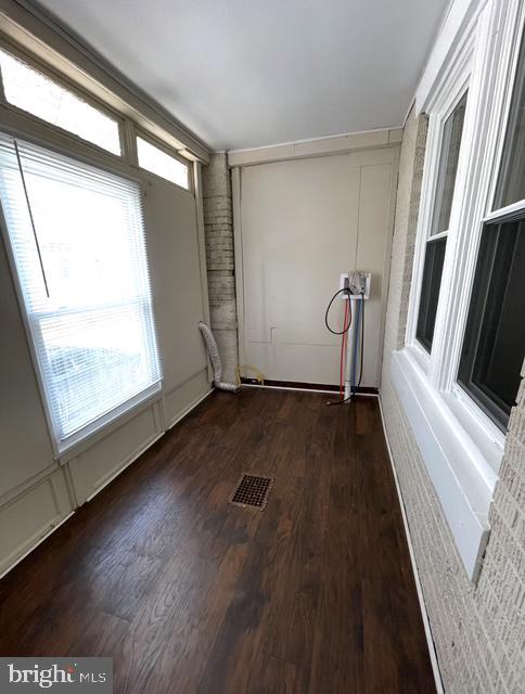empty room with dark wood-style flooring