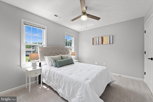carpeted bedroom featuring baseboards and a ceiling fan