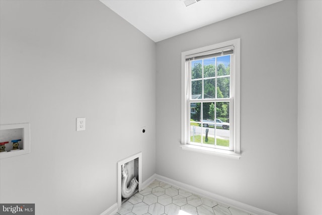 washroom featuring washer hookup, electric dryer hookup, baseboards, and light tile patterned flooring