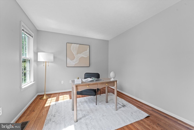 office space featuring wood finished floors and baseboards