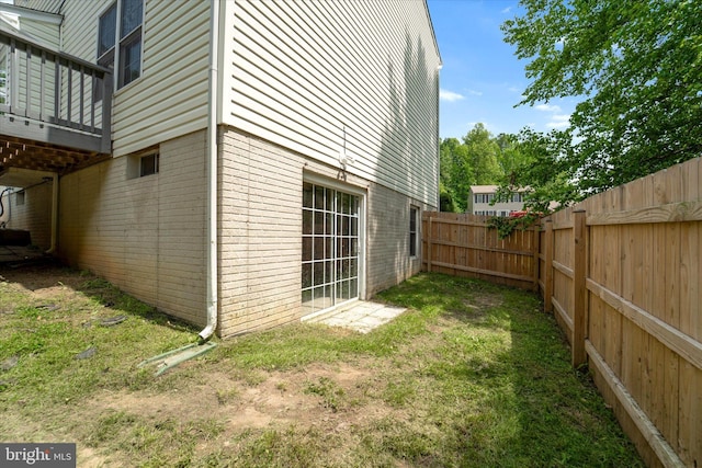 view of yard with fence and a deck