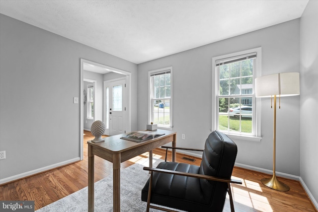office featuring baseboards and wood finished floors