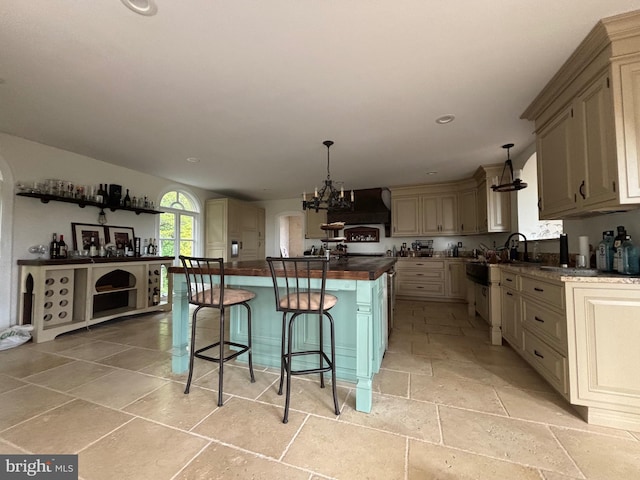 11500 Springridge Rd, Potomac, MD 20854 - kitchen with stone tile flooring, premium range hood, a chandelier, a center island, and cream cabinets