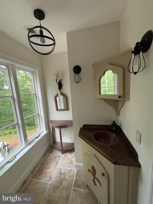 11500 Springridge Rd, Potomac, MD 20854 - bathroom featuring baseboards, stone finish floors, and vanity