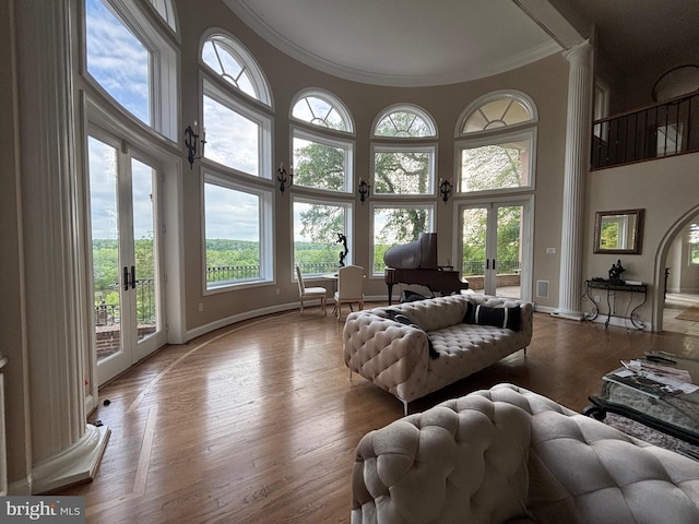 11500 Springridge Rd, Potomac, MD 20854 - living area featuring french doors, a towering ceiling, crown molding, baseboards, and ornate columns
