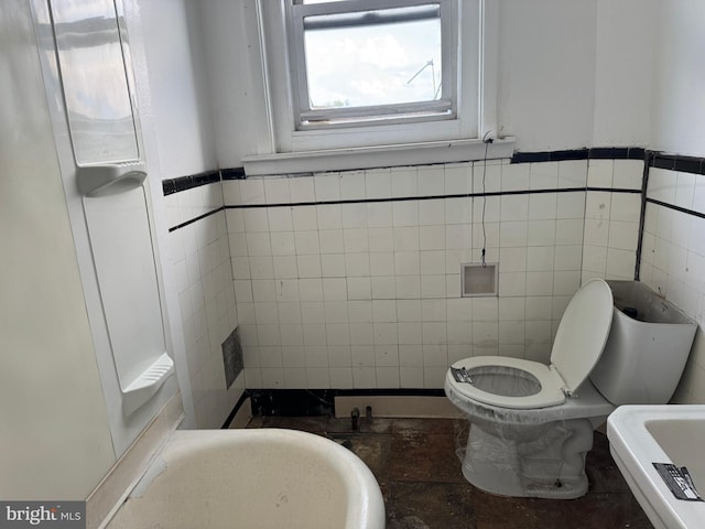 531 N 63rd St, Philadelphia, PA 19151 - bathroom with tile walls, a wainscoted wall, and toilet