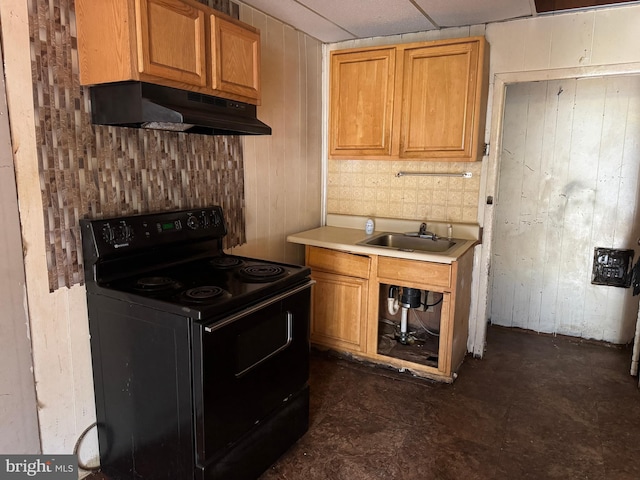 531 N 63rd St, Philadelphia, PA 19151 - kitchen with a sink, light countertops, wooden walls, under cabinet range hood, and black range with electric cooktop