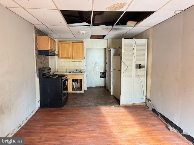 531 N 63rd St, Philadelphia, PA 19151 - kitchen featuring a sink, black electric range oven, freestanding refrigerator, wood finished floors, and under cabinet range hood