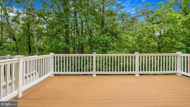 deck featuring view of wooded area