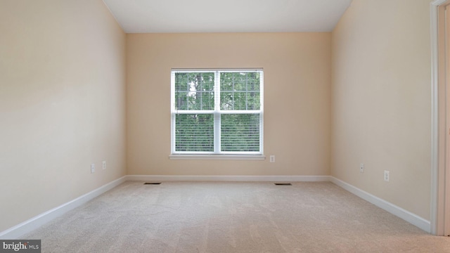 carpeted spare room with baseboards
