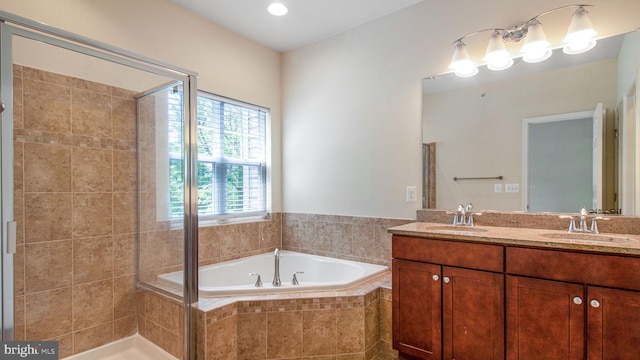 full bath featuring a bath, a stall shower, and double vanity