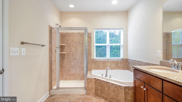 bathroom featuring a stall shower, a garden tub, vanity, tile patterned floors, and recessed lighting