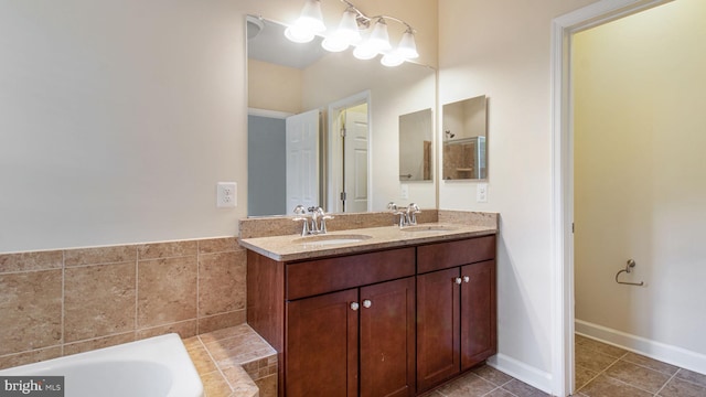 full bathroom featuring double vanity, tile patterned floors, and a tub