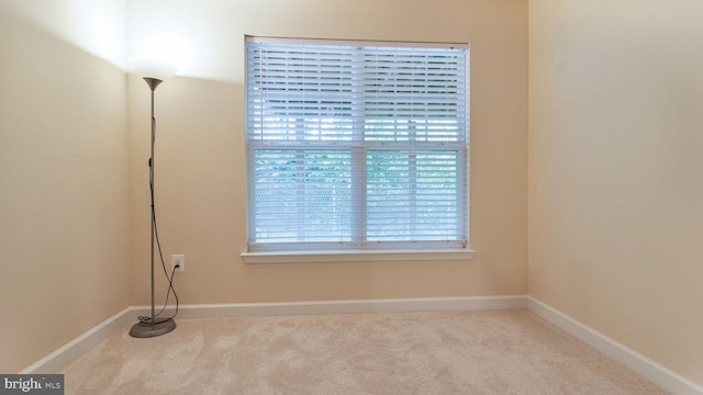 empty room with carpet floors and baseboards