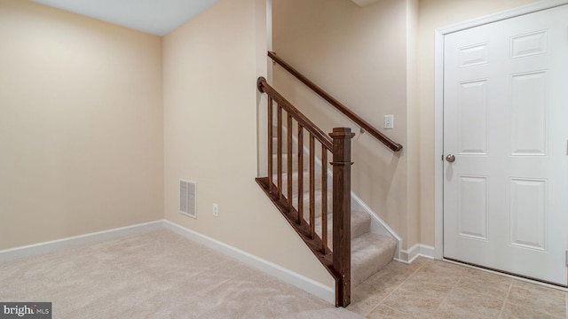 stairway with baseboards and carpet