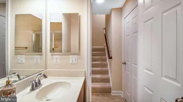 bathroom featuring vanity, tile patterned flooring, and baseboards
