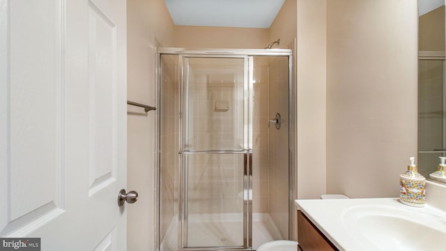 full bathroom with a stall shower and vanity