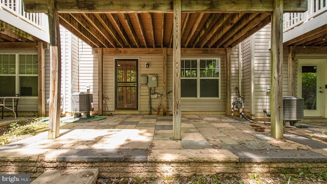property entrance with central AC and a patio