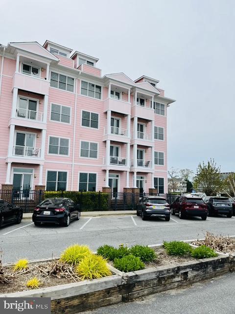 9000 Bay Ave Unit 209, North Beach, MD 20714 - view of building exterior with uncovered parking