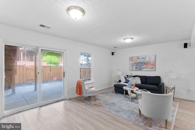 2505 Wheat Meadow Ct, Herndon, VA 20171 - living room featuring wood finished floors, a textured ceiling, and baseboards