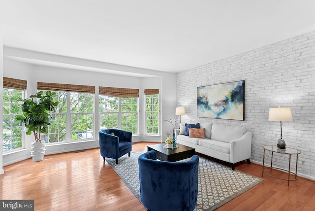 2505 Wheat Meadow Ct, Herndon, VA 20171 - living room featuring hardwood / wood-style flooring and brick wall