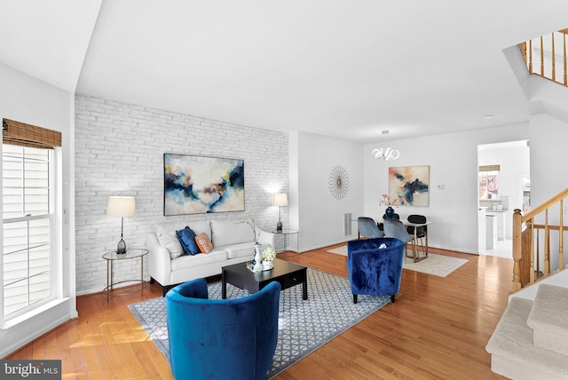 2505 Wheat Meadow Ct, Herndon, VA 20171 - living area featuring stairs, wood finished floors, and brick wall