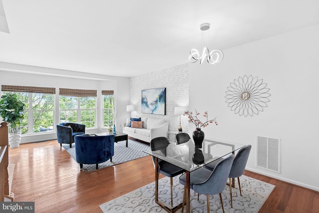 2505 Wheat Meadow Ct, Herndon, VA 20171 - dining room featuring wood finished floors, a chandelier, and baseboards