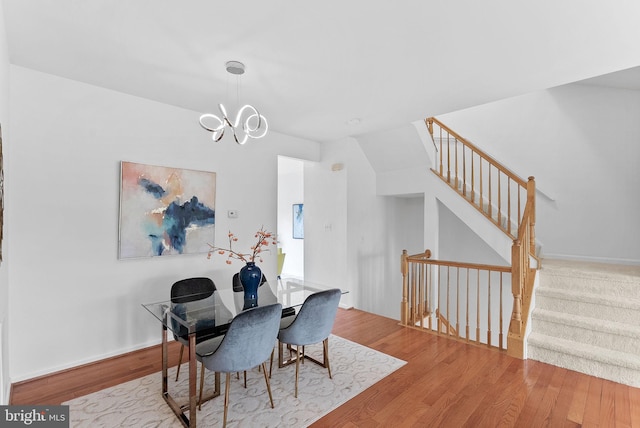 2505 Wheat Meadow Ct, Herndon, VA 20171 - dining space featuring wood finished floors, a chandelier, stairs, and baseboards