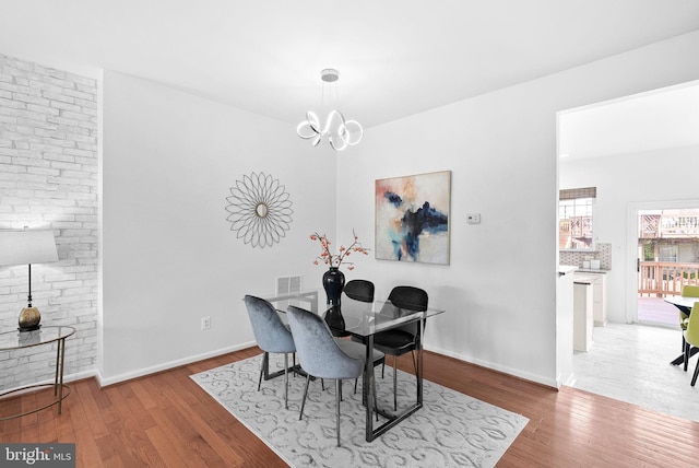 2505 Wheat Meadow Ct, Herndon, VA 20171 - dining space with wood finished floors, a chandelier, and baseboards