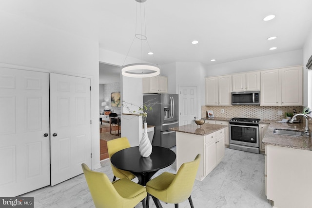 2505 Wheat Meadow Ct, Herndon, VA 20171 - kitchen with appliances with stainless steel finishes, a sink, a kitchen island, tasteful backsplash, and dark stone counters