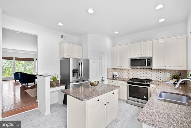 2505 Wheat Meadow Ct, Herndon, VA 20171 - kitchen with appliances with stainless steel finishes, a sink, light stone countertops, light marble finish floors, and decorative backsplash