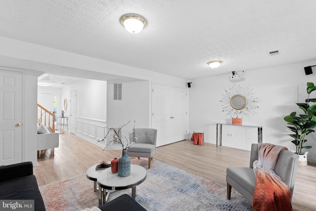 2505 Wheat Meadow Ct, Herndon, VA 20171 - living area with wood finished floors, stairway, and a textured ceiling