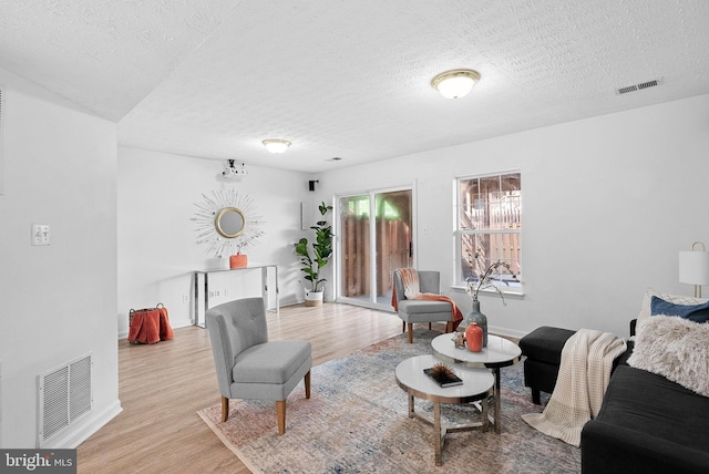2505 Wheat Meadow Ct, Herndon, VA 20171 - living area with a textured ceiling, wood finished floors, and baseboards