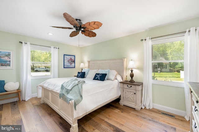bedroom with recessed lighting, baseboards, and light wood-style floors