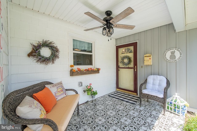 doorway to property with a porch and a ceiling fan