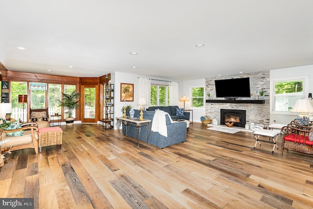 living room featuring a fireplace, hardwood / wood-style flooring, and recessed lighting
