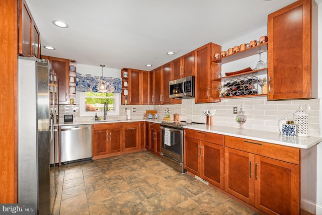 kitchen with stone finish flooring, a sink, open shelves, appliances with stainless steel finishes, and tasteful backsplash